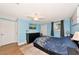 Charming bedroom with wood floors, blue walls, ceiling fan, and natural light at 2004 19Th W St, Bradenton, FL 34205