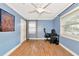 Bright bedroom featuring wood floors, a ceiling fan, and large windows at 2004 19Th W St, Bradenton, FL 34205