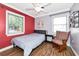 Comfortable bedroom with wood floors, large windows, and a cozy armchair at 2004 19Th W St, Bradenton, FL 34205