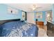 Bright bedroom featuring blue walls, laminate floors, and a ceiling fan at 2004 19Th W St, Bradenton, FL 34205