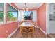 Dining room featuring wood floors, large windows, and views of the fenced backyard at 2004 19Th W St, Bradenton, FL 34205