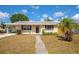Inviting single-story home featuring a cozy front yard with a palm tree at 2004 19Th W St, Bradenton, FL 34205
