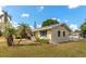 Quaint one-story home with palm trees, a fenced yard, and a charming aesthetic at 2004 19Th W St, Bradenton, FL 34205