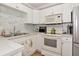 Kitchen with white cabinets, stainless steel appliances, and tile backsplash at 2004 19Th W St, Bradenton, FL 34205