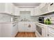 Clean white kitchen with stainless steel sink and modern backsplash tiles at 2004 19Th W St, Bradenton, FL 34205