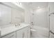 Clean bathroom featuring a bathtub with shower, large mirror, and ample storage at 204 Eagleston Ln, Lakewood Ranch, FL 34240
