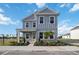 Charming two-story home with blue siding, a covered porch, and well-manicured landscaping at 204 Eagleston Ln, Lakewood Ranch, FL 34240