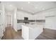 Modern kitchen featuring a spacious island, stainless steel appliances, and hardwood floors at 204 Eagleston Ln, Lakewood Ranch, FL 34240