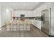 Modern kitchen with white cabinetry, stainless steel appliances, and a spacious island with seating at 204 Eagleston Ln, Lakewood Ranch, FL 34240