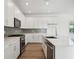 Gourmet kitchen featuring stainless steel appliances, quartz counters, and white cabinets at 204 Eagleston Ln, Lakewood Ranch, FL 34240