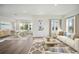 Bright living room featuring a stylish rug, a comfortable white sofa, and an adjacent dining area at 204 Eagleston Ln, Lakewood Ranch, FL 34240