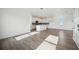 Open-concept living space with white cabinets, modern appliances, and hardwood flooring at 204 Eagleston Ln, Lakewood Ranch, FL 34240