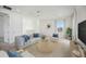 Cozy living room with a comfortable sofa, a round coffee table, and plenty of natural light at 204 Eagleston Ln, Lakewood Ranch, FL 34240