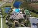 Breathtaking aerial view showcasing the community's pool, clubhouse, tennis courts, bocce ball and lush surroundings at 229 Alento Ct, Nokomis, FL 34275