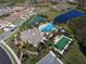 Aerial view of a beautiful community with a pool, clubhouse, tennis courts, and bocce ball at 229 Alento Ct, Nokomis, FL 34275