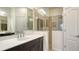 Modern bathroom with granite vanity, dual sinks, walk-in shower with glass partition, and linen closet at 229 Alento Ct, Nokomis, FL 34275