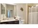 Well-appointed bathroom featuring granite vanity, chrome fixtures, large mirror, and shower with decorative turtle art at 229 Alento Ct, Nokomis, FL 34275