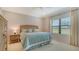 Serene bedroom featuring a queen-sized bed, soft lighting, and a bright window with peaceful outdoor views at 229 Alento Ct, Nokomis, FL 34275