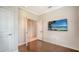 Bright bedroom with wood floors and large TV at 229 Alento Ct, Nokomis, FL 34275