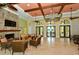 Welcoming clubhouse interior with a cozy fireplace, stylish seating, and large windows overlooking the pool area at 229 Alento Ct, Nokomis, FL 34275