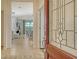 Inviting entryway featuring an open view into the living area through the decorative glass front door at 229 Alento Ct, Nokomis, FL 34275
