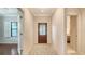 Bright entryway with wood floors, a decorative front door, and views into the bedrooms and living areas at 229 Alento Ct, Nokomis, FL 34275