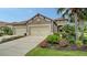 Charming home featuring a well-maintained front yard with lush landscaping, three car garage and a tile roof at 229 Alento Ct, Nokomis, FL 34275