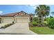 Charming home featuring a well-maintained front yard with lush landscaping, three car garage and a tile roof at 229 Alento Ct, Nokomis, FL 34275
