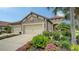 Charming home featuring a well-maintained front yard with lush landscaping, three car garage and a tile roof at 229 Alento Ct, Nokomis, FL 34275