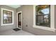 Welcoming front porch with two windows and a decorative front door at 229 Alento Ct, Nokomis, FL 34275