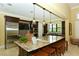 Gourmet kitchen with granite island, stainless steel appliances, and custom cabinetry at 229 Alento Ct, Nokomis, FL 34275