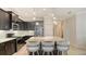 Gourmet kitchen featuring dark cabinets, a large island with seating, and stainless steel appliances at 229 Alento Ct, Nokomis, FL 34275