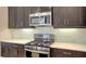 Modern kitchen features stainless steel appliances and white backsplash at 229 Alento Ct, Nokomis, FL 34275