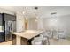 Modern kitchen features dark cabinets, stainless appliances, and a marble island with seating at 229 Alento Ct, Nokomis, FL 34275
