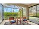 Cozy screened lanai with outdoor seating and views of well-maintained greenery for peaceful relaxation at 229 Alento Ct, Nokomis, FL 34275