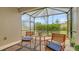 Inviting screened lanai offering a tranquil space with outdoor seating and picturesque views of the garden at 229 Alento Ct, Nokomis, FL 34275