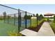 A fenced-in pickleball court with lush landscaping at 229 Alento Ct, Nokomis, FL 34275