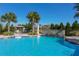 Stunning community pool with a rock waterfall, lounge chairs, and lush landscaping for resort-style living at 229 Alento Ct, Nokomis, FL 34275