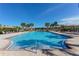 Inviting community pool with clear blue water, lounge chairs, and palm trees, ideal for sunny days at 229 Alento Ct, Nokomis, FL 34275