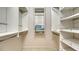Spacious walk-in closet with custom shelving and ample storage space for organizing clothes and accessories at 229 Alento Ct, Nokomis, FL 34275