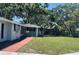 View of the home's front lawn with lush green grass and mature trees, creating a serene and inviting outdoor space at 236 Davis Blvd, Sarasota, FL 34237