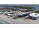 Stunning aerial view of a beachfront condo with beach access and a tiki hut at 2400 N Beach Rd # 1, Englewood, FL 34223