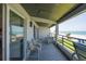 Spacious, covered outdoor deck with seating that overlooks views of the beach and ocean at 2400 N Beach Rd # 1, Englewood, FL 34223