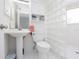 Clean, efficient bathroom with glass-blocked shower, pedestal sink, and ample natural light at 2400 N Beach Rd # 1, Englewood, FL 34223