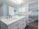 Bathroom features a double sink vanity with brushed nickel hardware and a view to the bedroom at 2400 N Beach Rd # 1, Englewood, FL 34223