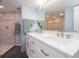 Modern bathroom with a double sink vanity, granite countertops, and a glass-enclosed shower at 2400 N Beach Rd # 1, Englewood, FL 34223