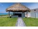 Inviting beach cabana with shaded seating area, ideal for enjoying the coastal scenery and ocean breezes at 2400 N Beach Rd # 1, Englewood, FL 34223