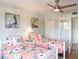 Charming bedroom with twin beds featuring floral bedding and beach themed decor at 2400 N Beach Rd # 1, Englewood, FL 34223