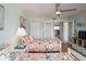 Bright bedroom with twin beds, floral bedding, and a view of the kitchen area at 2400 N Beach Rd # 1, Englewood, FL 34223