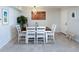Cozy dining room with seating for four adjacent to large wall cabinet and the main entry door at 2400 N Beach Rd # 1, Englewood, FL 34223